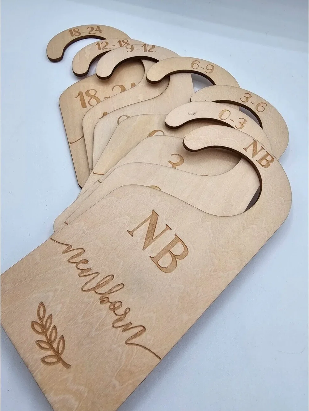 Wooden baby closet dividers used for organizing baby clothes by size